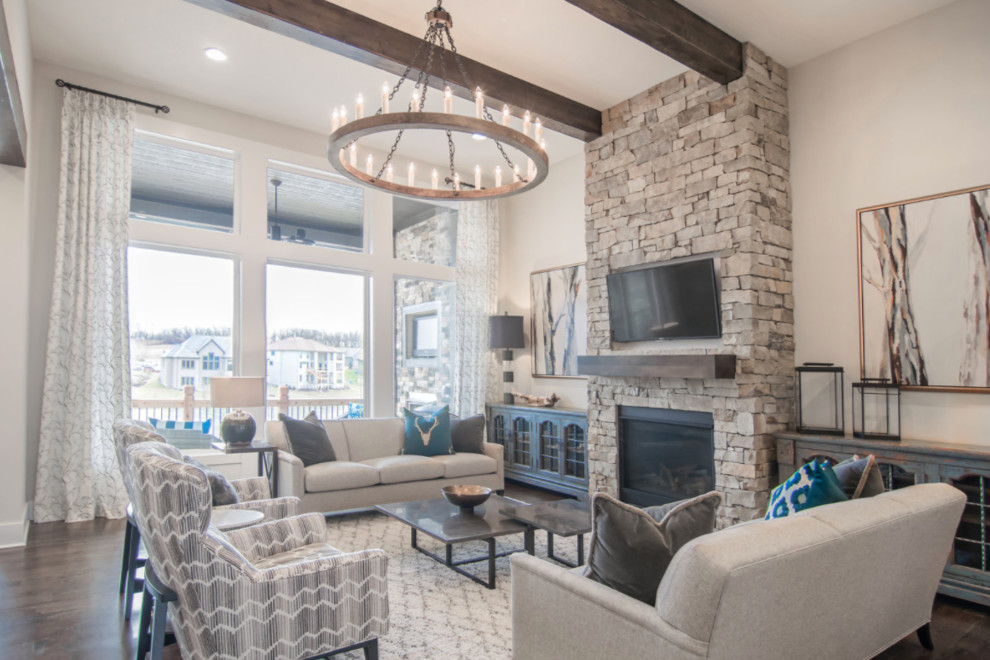 Design ideas for a large traditional open concept family room in Kansas City with white walls, dark hardwood floors, a standard fireplace, a stone fireplace surround and a wall-mounted tv.