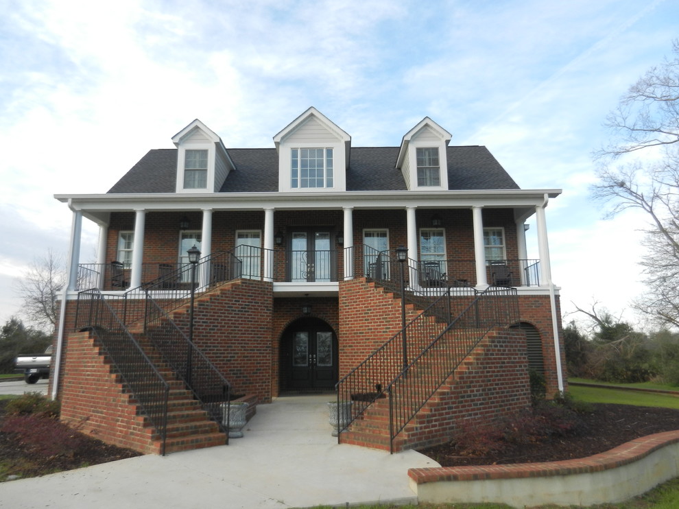 This is an example of a mid-sized traditional three-storey brick exterior in Charleston with a gable roof.