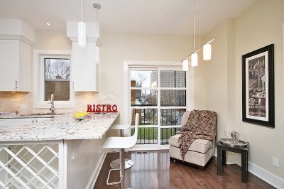 Inspiration for a large transitional u-shaped medium tone wood floor kitchen remodel in Ottawa with an undermount sink, flat-panel cabinets, white cabinets, beige backsplash and a peninsula
