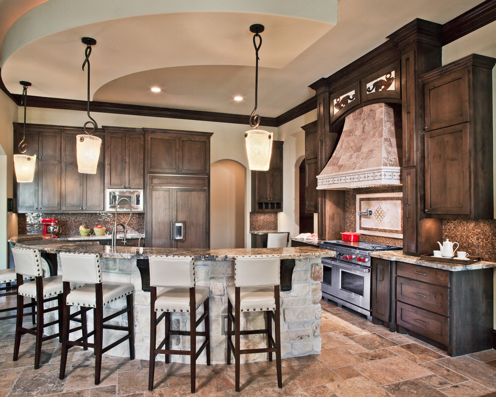 This is an example of a traditional kitchen in Dallas with granite benchtops and panelled appliances.