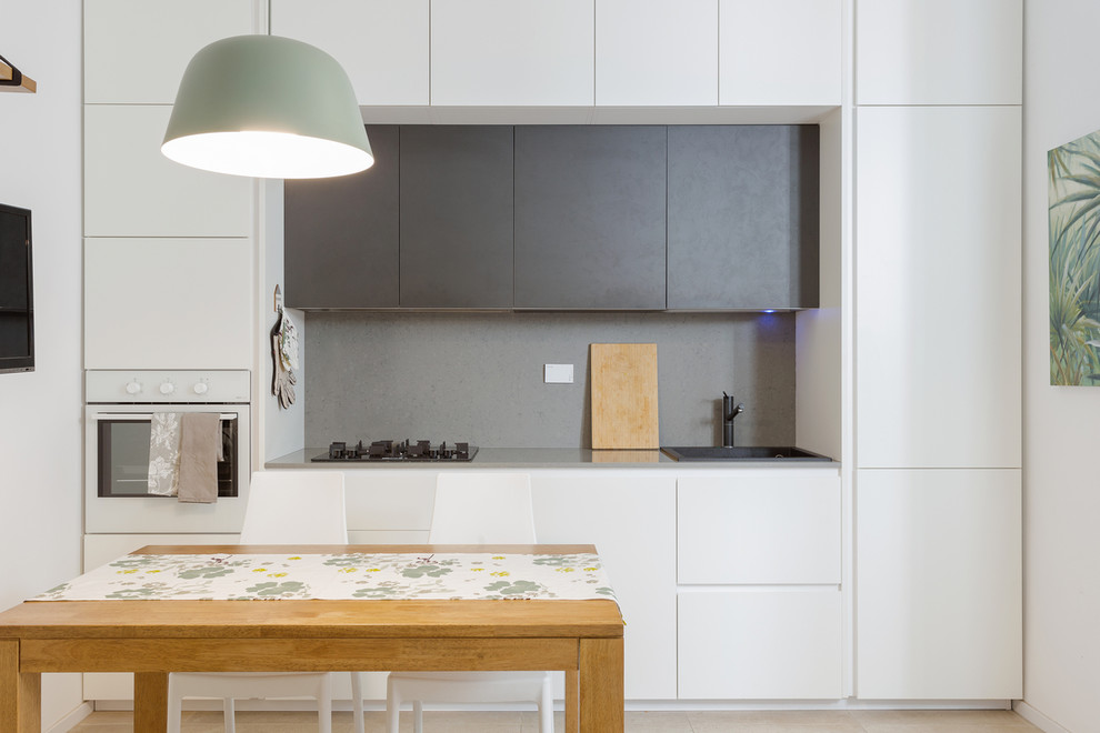 Design ideas for a small contemporary single-wall eat-in kitchen in Rome with flat-panel cabinets, white cabinets, grey splashback and no island.