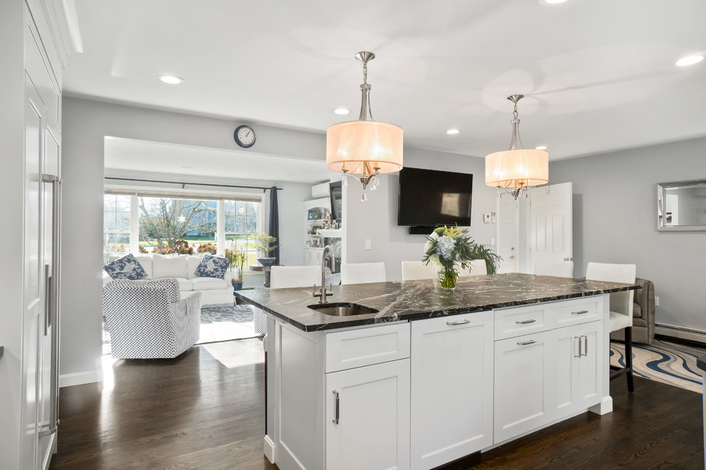 Inspiration for a huge transitional u-shaped dark wood floor and brown floor eat-in kitchen remodel in Providence with an undermount sink, recessed-panel cabinets, white cabinets, granite countertops, white backsplash, marble backsplash, stainless steel appliances and an island