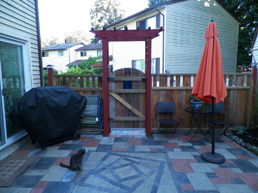Photo of a small eclectic backyard patio in Vancouver with a vegetable garden, concrete pavers and no cover.