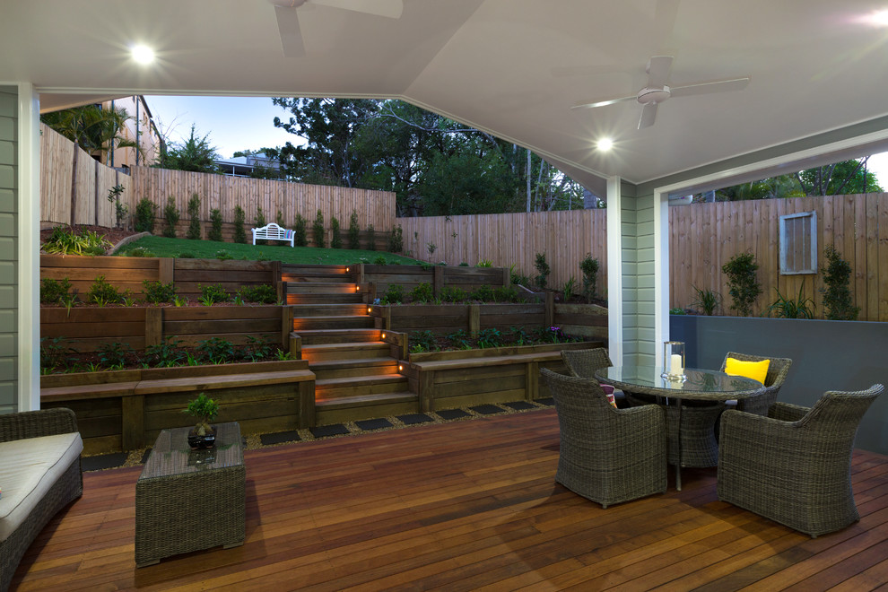 Traditional backyard deck in Brisbane with a roof extension.