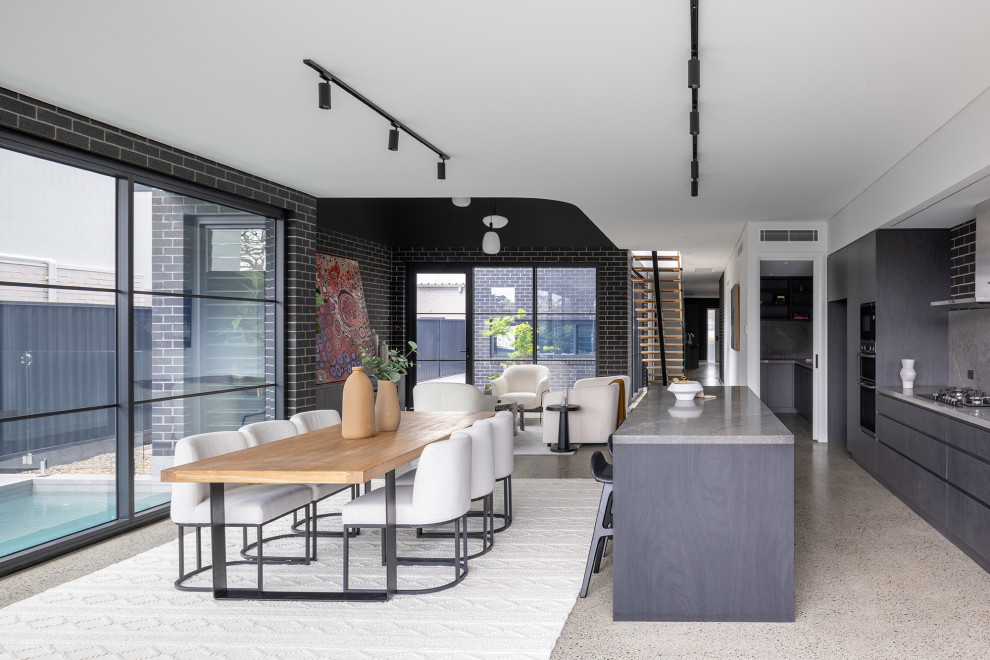 This is an example of a contemporary kitchen in Sydney with dark wood cabinets.