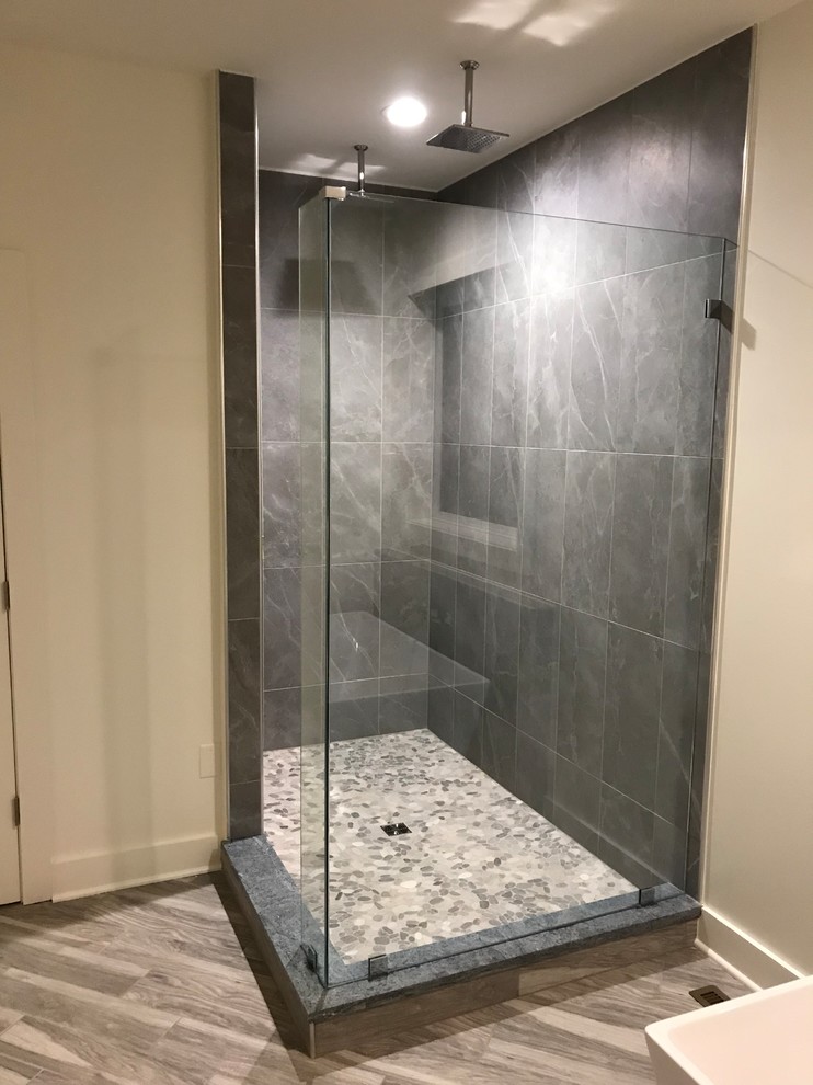 Design ideas for a mid-sized transitional master bathroom in DC Metro with white cabinets, a freestanding tub, a corner shower, gray tile, slate, white walls, vinyl floors, brown floor, an open shower and black benchtops.