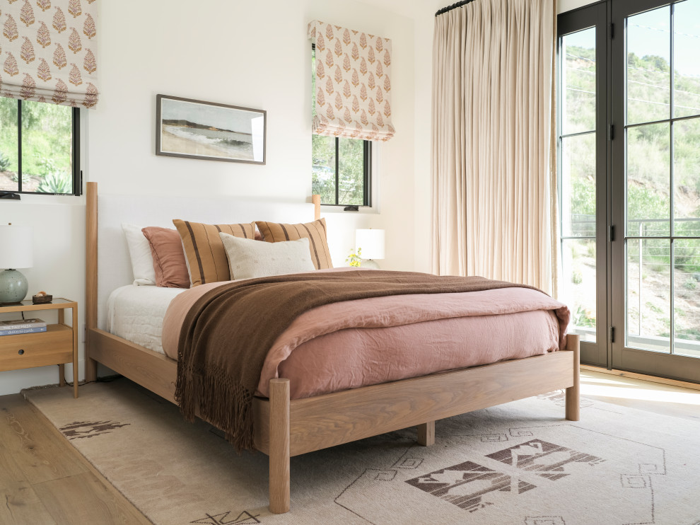 Mid-sized beach style master light wood floor, brown floor and shiplap ceiling bedroom photo in Los Angeles with white walls