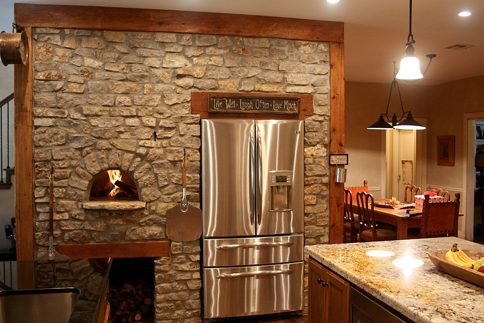 Large mountain style u-shaped medium tone wood floor open concept kitchen photo with recessed-panel cabinets, medium tone wood cabinets, granite countertops, beige backsplash, stone tile backsplash, stainless steel appliances and two islands