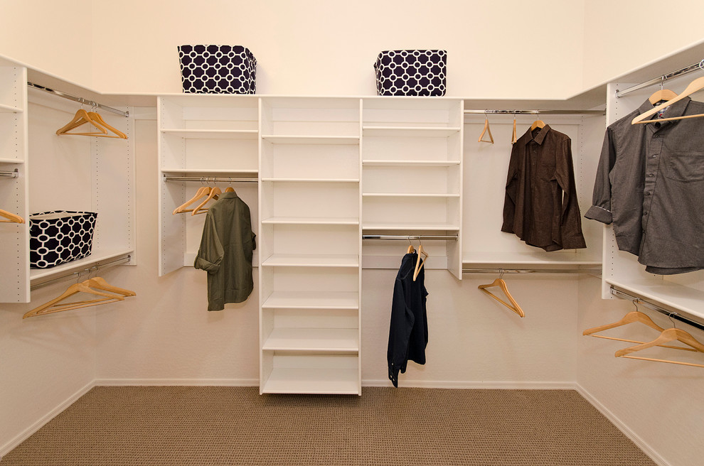 Mid-sized traditional gender-neutral walk-in wardrobe in Phoenix with open cabinets, white cabinets and carpet.