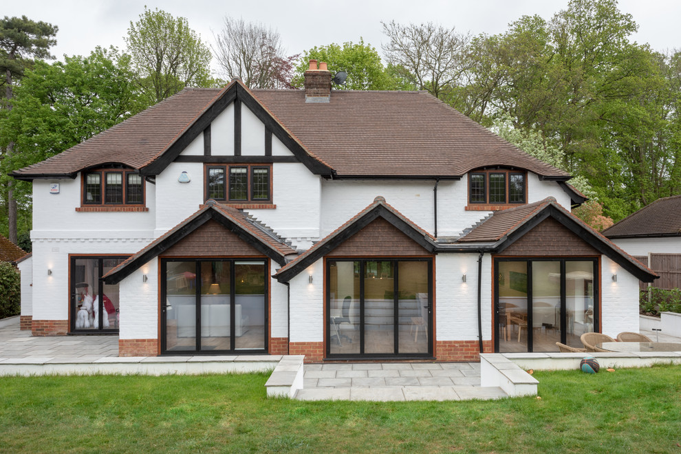 Inspiration for a traditional two-storey white house exterior in Surrey with a gable roof.