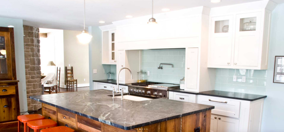 Example of a mid-sized transitional l-shaped kitchen design in San Diego with a farmhouse sink, shaker cabinets, white cabinets, blue backsplash, porcelain backsplash, stainless steel appliances and an island