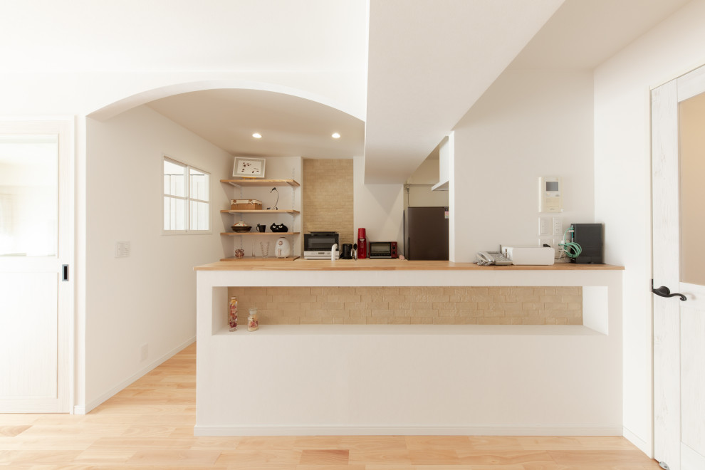 Design ideas for a small traditional galley eat-in kitchen with an undermount sink, red cabinets, solid surface benchtops, pink splashback, stainless steel appliances, medium hardwood floors, a peninsula, beige floor and white benchtop.