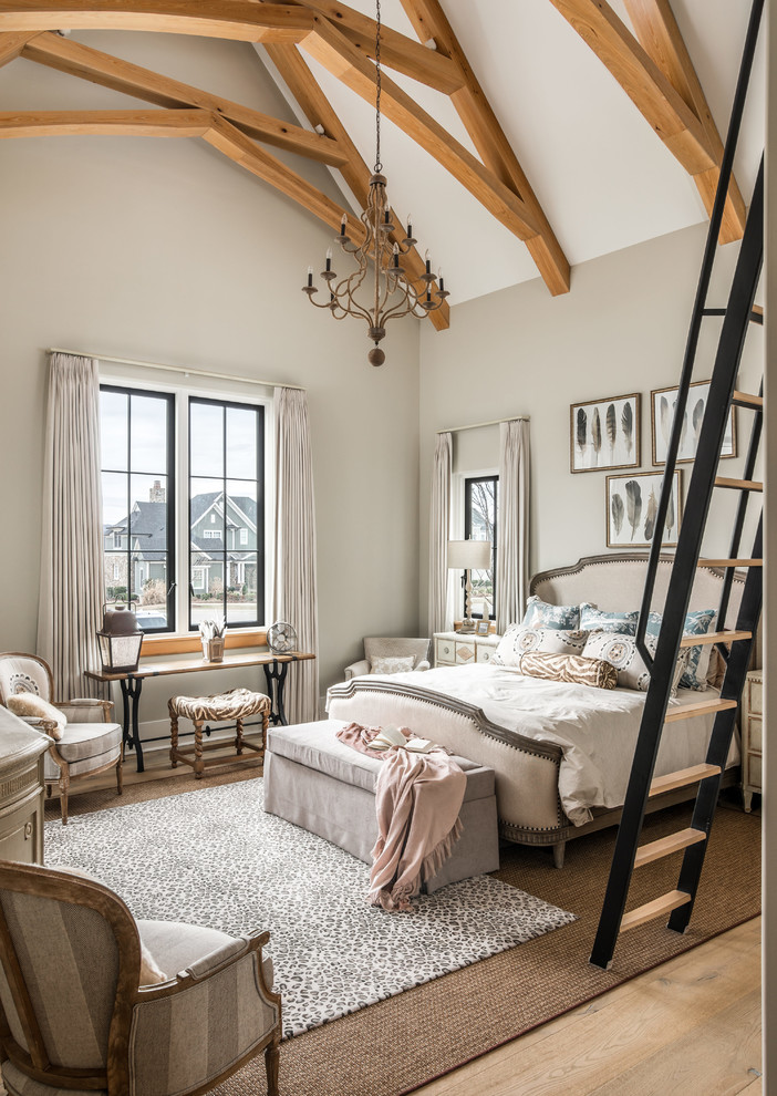 Photo of a traditional master bedroom in Nashville with beige walls, medium hardwood floors and brown floor.