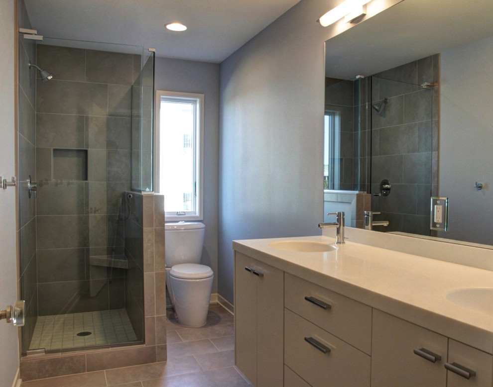 Inspiration for a contemporary bathroom in Wilmington with an integrated sink, flat-panel cabinets, grey cabinets, a corner shower, ceramic tile, blue walls and ceramic floors.