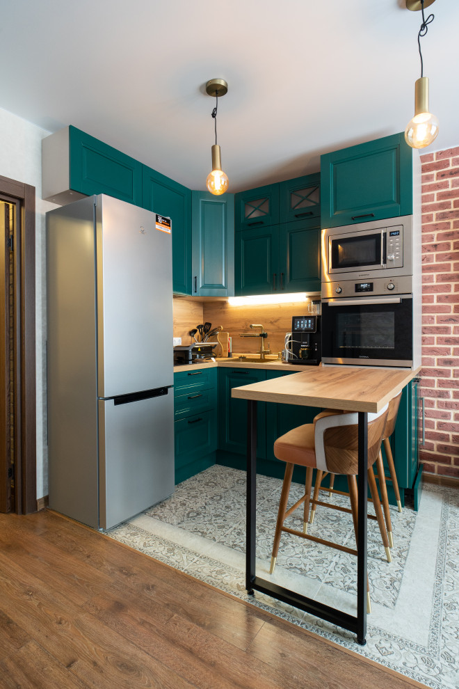 This is an example of a small classic l-shaped kitchen/diner in Moscow with a single-bowl sink, recessed-panel cabinets, turquoise cabinets, laminate countertops, beige splashback, wood splashback, integrated appliances, a breakfast bar and beige worktops.
