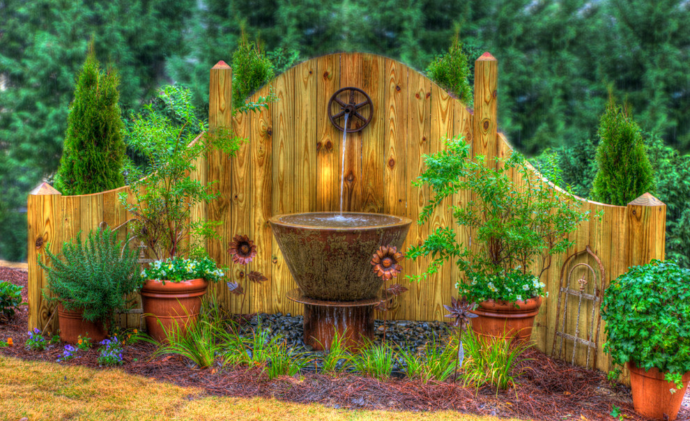 Inspiration for a traditional backyard garden in Birmingham with a water feature.