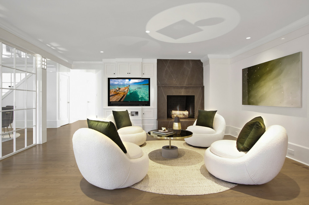 This is an example of a mid-sized contemporary open concept family room in New York with white walls, medium hardwood floors, a standard fireplace, a stone fireplace surround and a wall-mounted tv.