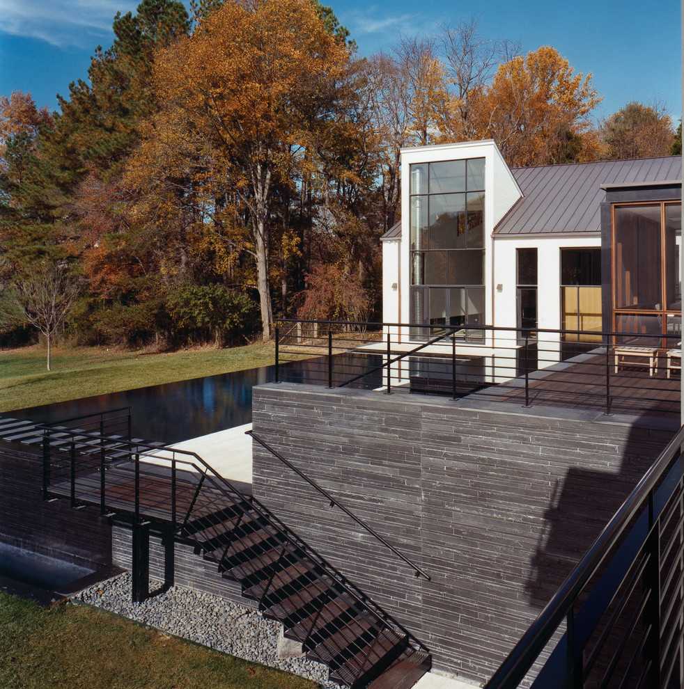 Photo of a contemporary rectangular pool in DC Metro with decking.