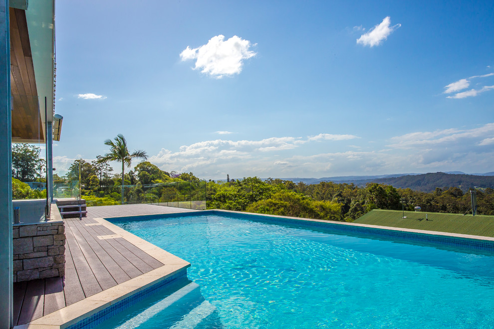 Large contemporary backyard rectangular lap pool in Sunshine Coast with decking.