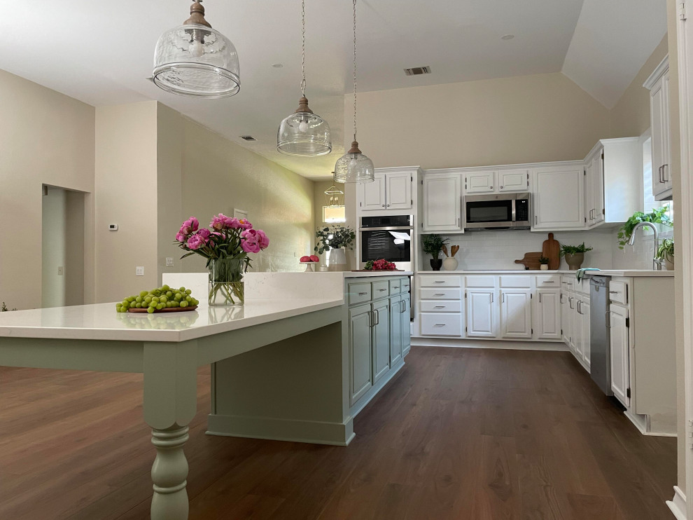 Kitchen - l-shaped kitchen idea with a single-bowl sink, white cabinets, white backsplash, subway tile backsplash, white countertops, quartz countertops, stainless steel appliances and an island