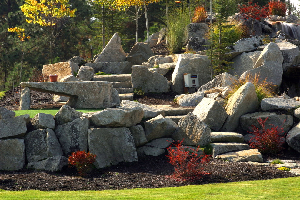 Inspiration for a large eclectic drought-tolerant backyard stone landscaping in Seattle.