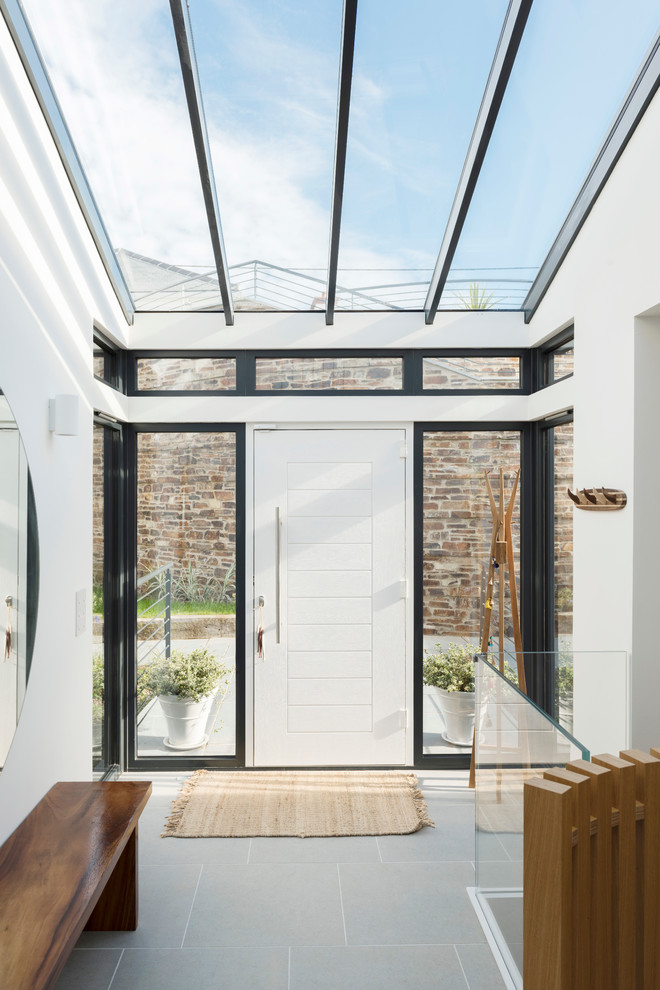 Inspiration for a contemporary foyer in Cornwall with white walls, a single front door and a white front door.