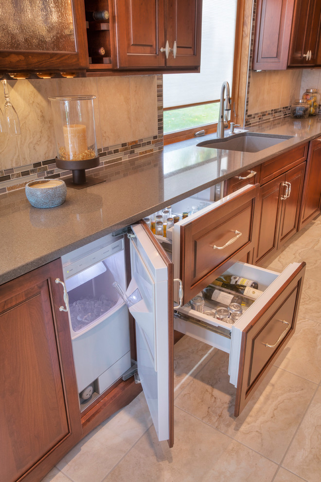 Large transitional l-shaped ceramic tile eat-in kitchen photo with an undermount sink, raised-panel cabinets, medium tone wood cabinets, glass countertops, multicolored backsplash, mosaic tile backsplash, paneled appliances and an island