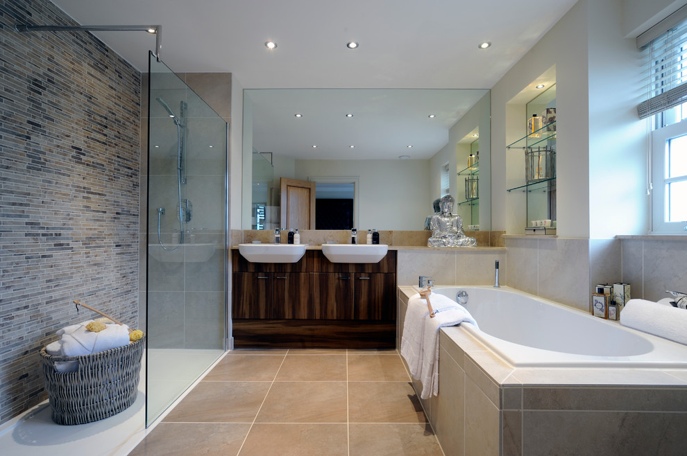 Inspiration for a transitional master bathroom in London with a vessel sink, flat-panel cabinets, dark wood cabinets, a drop-in tub and a curbless shower.