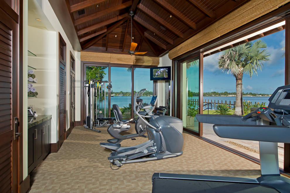 Inspiration for a large tropical multipurpose gym in Orlando with carpet, white walls and beige floor.