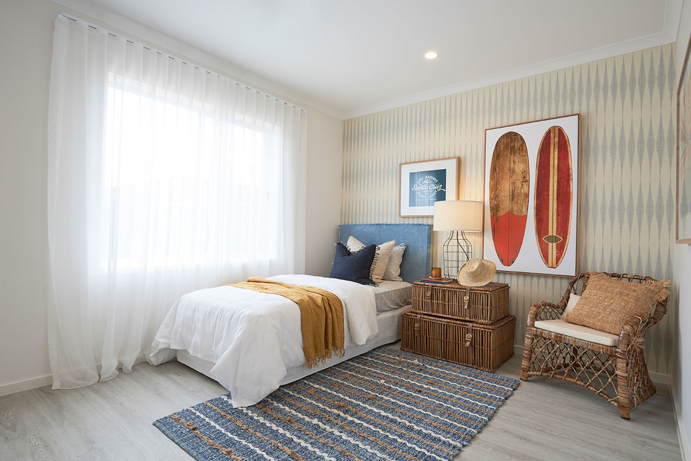 Photo of a beach style bedroom in Melbourne with white walls, light hardwood floors and beige floor.