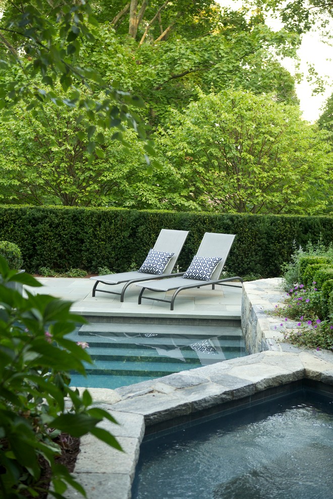 This is an example of a small traditional backyard patio in New York with natural stone pavers.