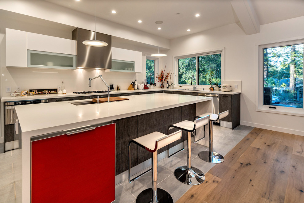Large contemporary u-shaped open plan kitchen in San Francisco with a drop-in sink, flat-panel cabinets, dark wood cabinets, quartz benchtops, white splashback, stainless steel appliances, with island, ceramic floors and grey floor.