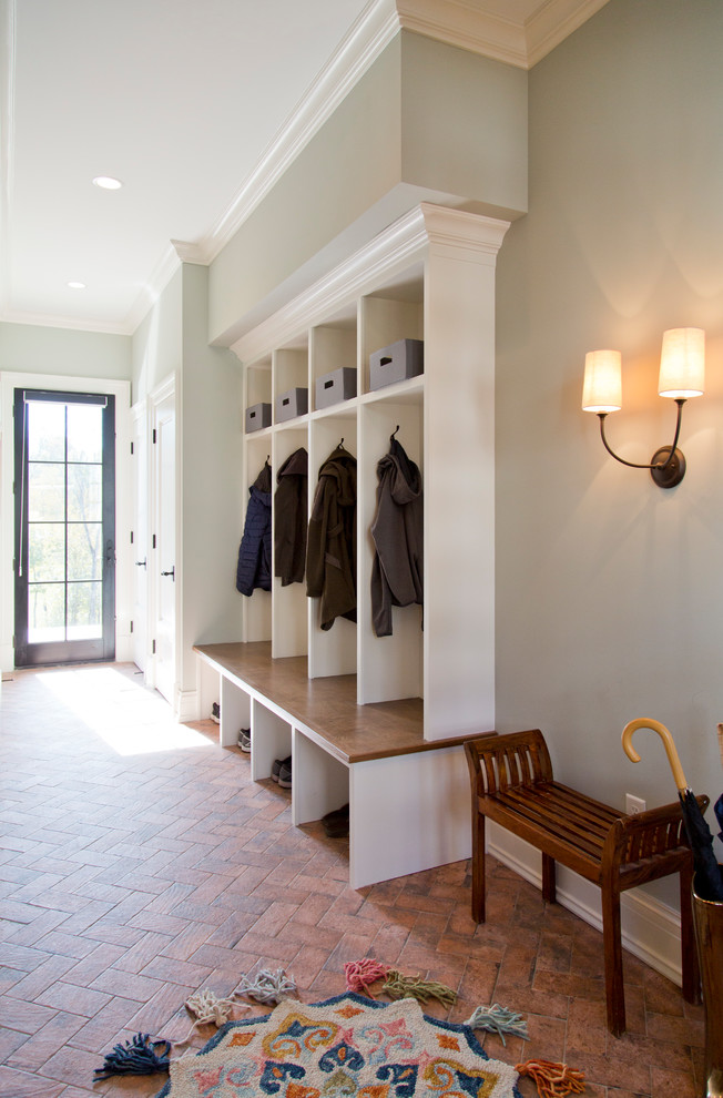 Large transitional mudroom in St Louis with grey walls, brick floors, a single front door, a black front door and red floor.