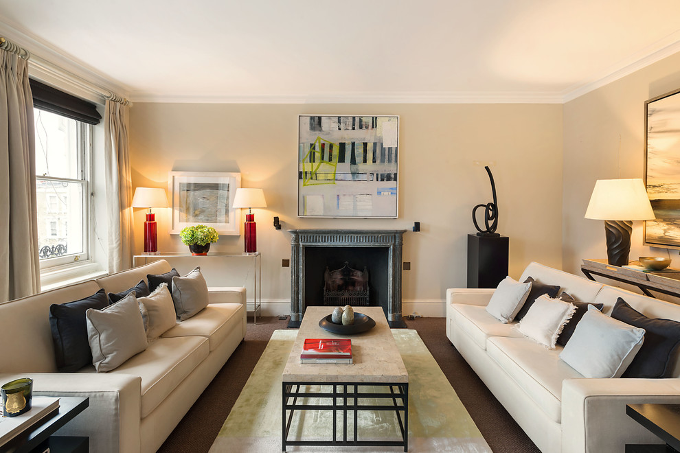 Transitional formal living room in London with beige walls, carpet, a standard fireplace and no tv.