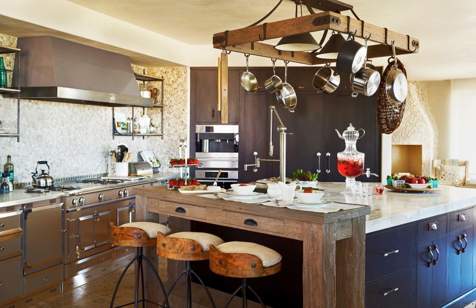Eat-in kitchen - eclectic eat-in kitchen idea in Phoenix with flat-panel cabinets, dark wood cabinets, beige backsplash, stainless steel appliances and an island