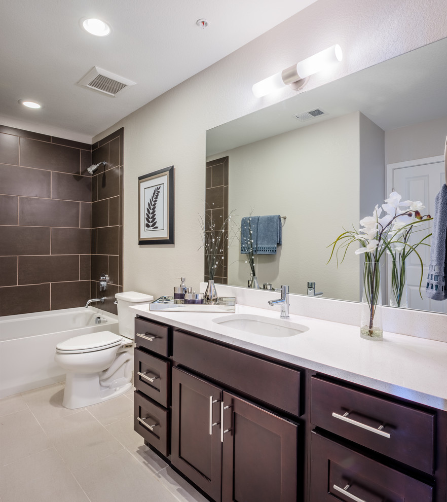 Inspiration for a small modern master bathroom in Denver with flat-panel cabinets, brown cabinets, a corner tub, a shower/bathtub combo, a one-piece toilet, brown tile, beige walls, a drop-in sink, beige floor and a shower curtain.