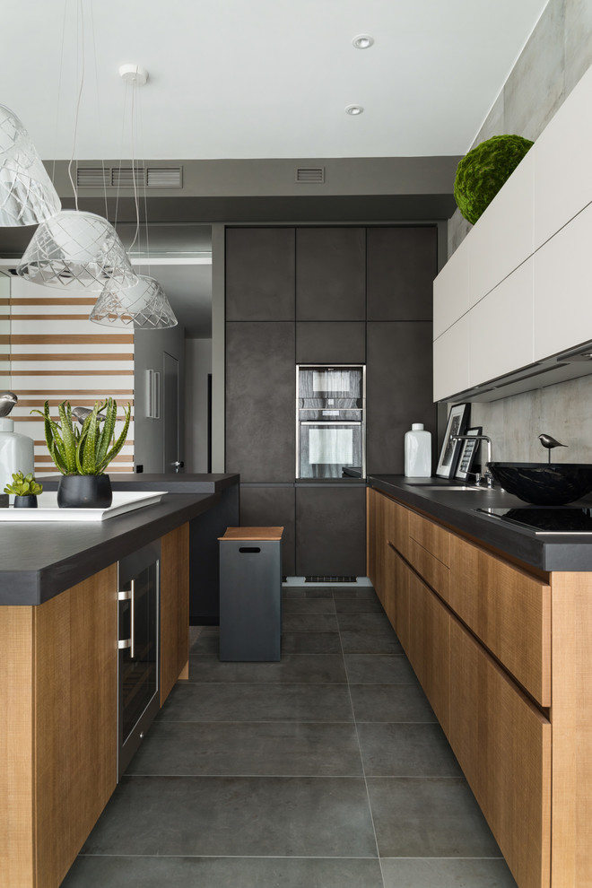 This is an example of a large contemporary l-shaped open plan kitchen in Moscow with medium hardwood floors, grey floor, an undermount sink, flat-panel cabinets, medium wood cabinets, quartz benchtops, grey splashback, porcelain splashback, black appliances and with island.