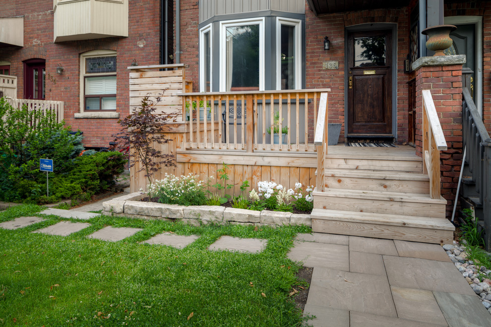 This is an example of an arts and crafts front yard verandah in Toronto with decking.