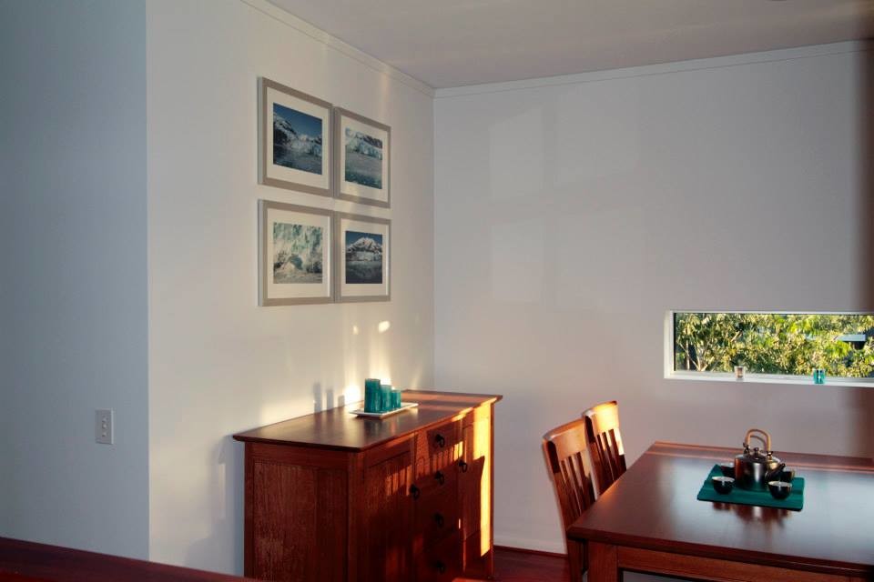 Small contemporary kitchen/dining combo in Brisbane with white walls and medium hardwood floors.