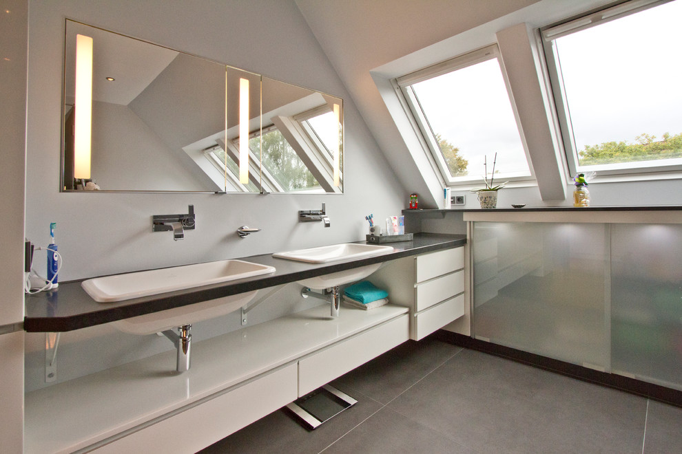 Large contemporary bathroom in Hamburg with a drop-in sink, flat-panel cabinets, white cabinets and grey walls.