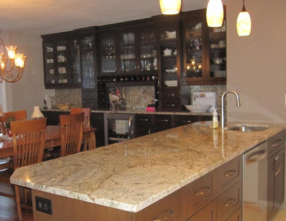 Example of a mid-sized transitional medium tone wood floor eat-in kitchen design in Ottawa with an undermount sink, shaker cabinets, medium tone wood cabinets, granite countertops, stainless steel appliances and an island