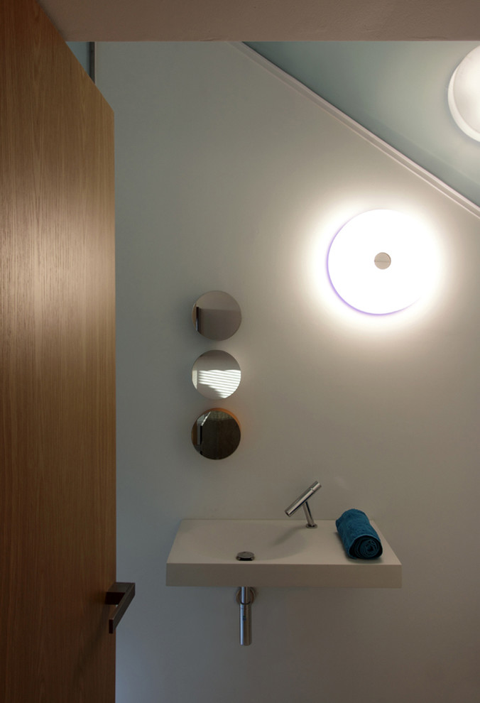 This is an example of a contemporary bathroom in Other with a wall-mount sink.
