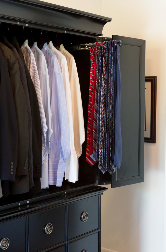 Design ideas for a large mediterranean men's walk-in wardrobe in San Diego with shaker cabinets, black cabinets and light hardwood floors.