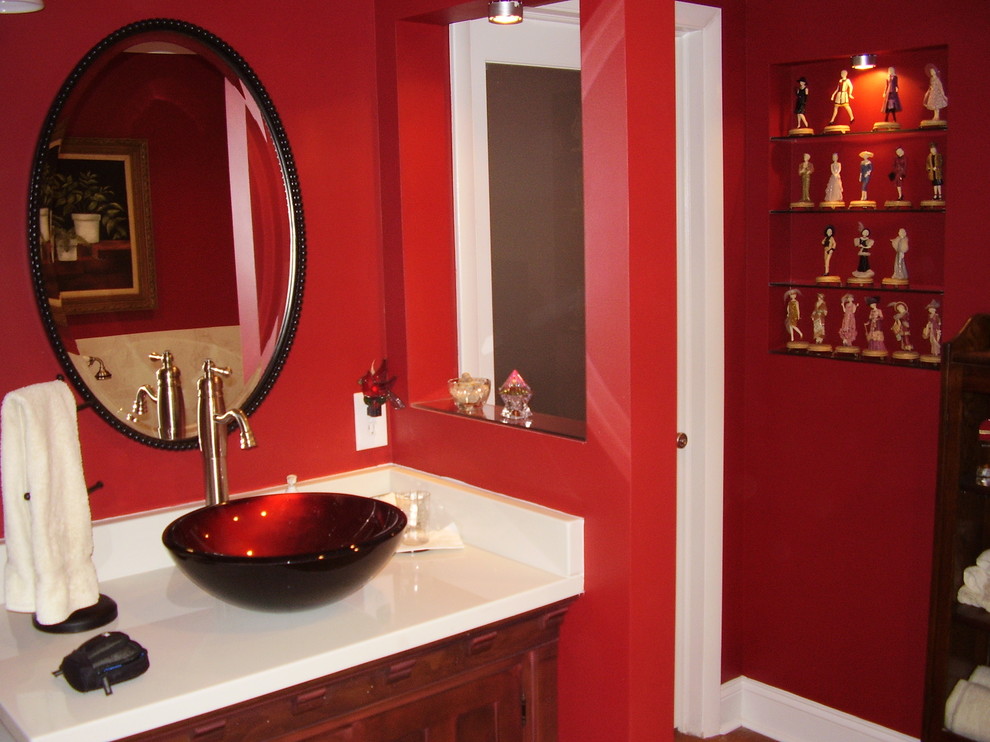 Photo of a mid-sized eclectic master bathroom in Atlanta with a vessel sink, furniture-like cabinets, dark wood cabinets, marble benchtops, a corner tub, an open shower, a one-piece toilet, beige tile, ceramic tile, red walls and ceramic floors.