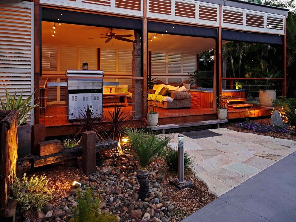Inspiration for a tropical one-storey beige exterior in Dallas with mixed siding.