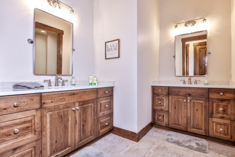 This is an example of a classic bathroom in Other with raised-panel cabinets, brown cabinets, a shower/bath combination, a two-piece toilet, white walls, porcelain flooring, a submerged sink, beige floors, a shower curtain, grey worktops, double sinks and a built in vanity unit.