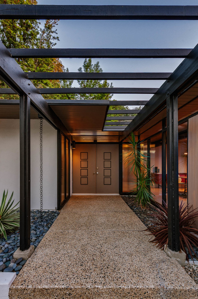 Inspiration for a mid-sized midcentury front door in Los Angeles with a double front door and a brown front door.