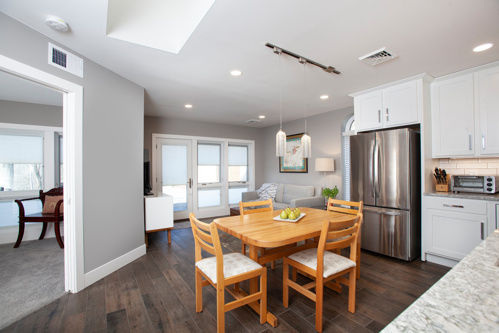 Eat-in kitchen - small transitional open concept and l-shaped porcelain tile and multicolored floor eat-in kitchen idea with gray walls, an undermount sink, shaker cabinets, white cabinets, quartz countertops, white backsplash, subway tile backsplash, stainless steel appliances, no island and white countertops