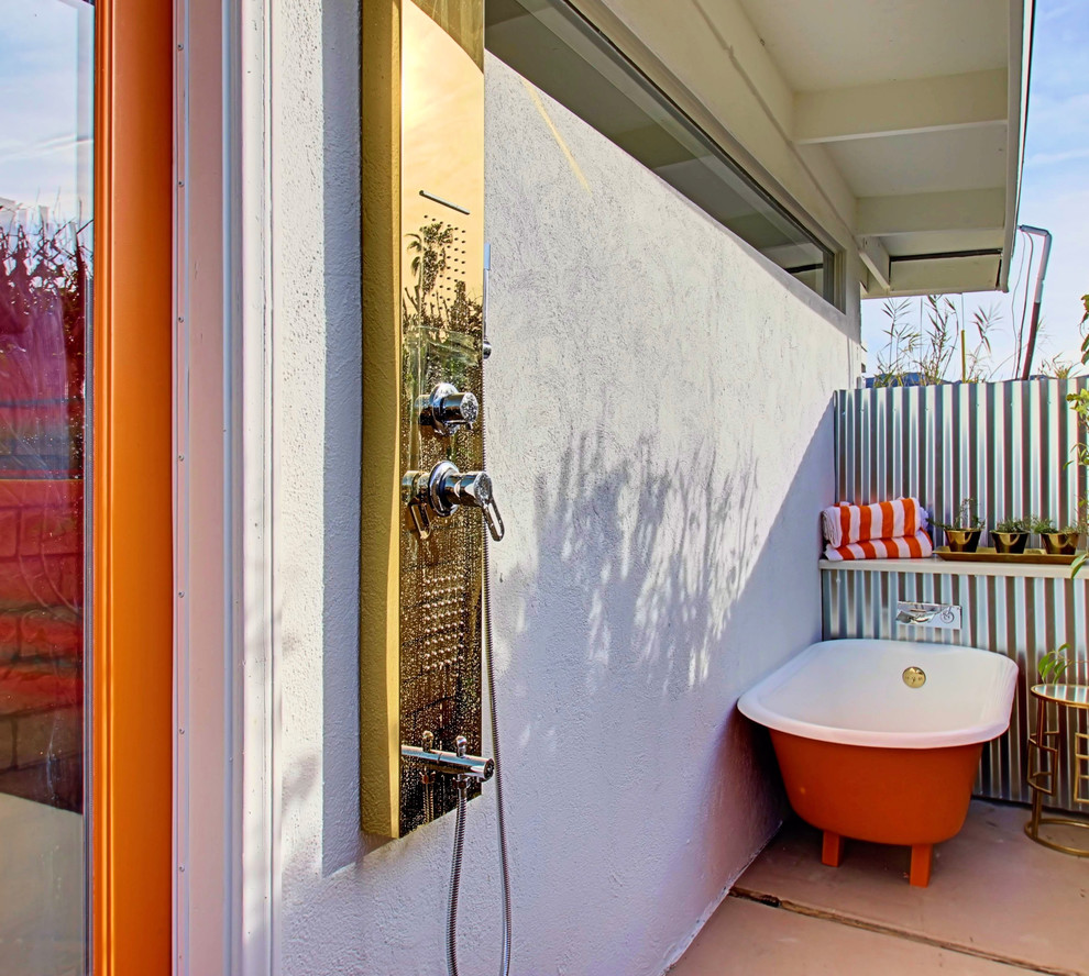 Photo of a mid-sized eclectic patio in Phoenix with an outdoor shower and a roof extension.