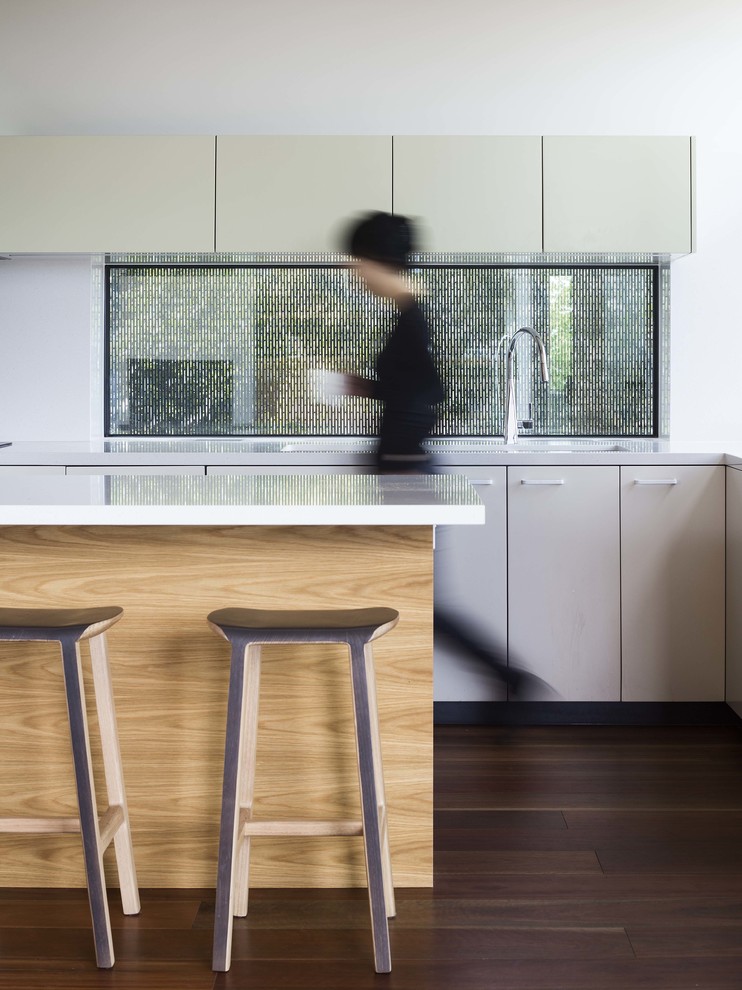 Mid-sized u-shaped eat-in kitchen in Melbourne with an integrated sink, beige cabinets, dark hardwood floors, with island, beaded inset cabinets, laminate benchtops, white splashback and ceramic splashback.